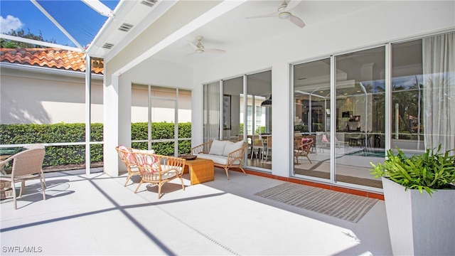 unfurnished sunroom featuring ceiling fan