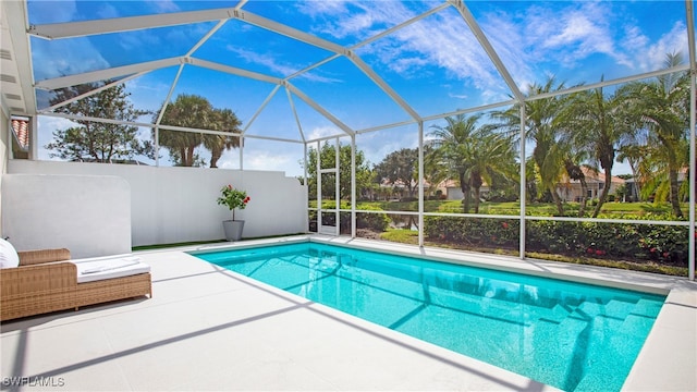 view of swimming pool with a patio and a lanai