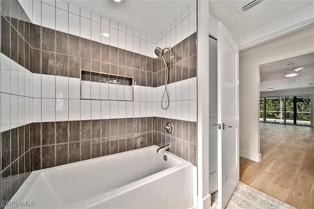 bathroom featuring tiled shower / bath, ceiling fan, and hardwood / wood-style flooring