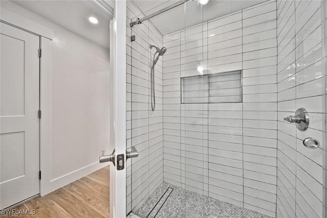 bathroom featuring hardwood / wood-style flooring and a shower with door