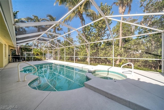 view of pool with glass enclosure, an in ground hot tub, and a patio