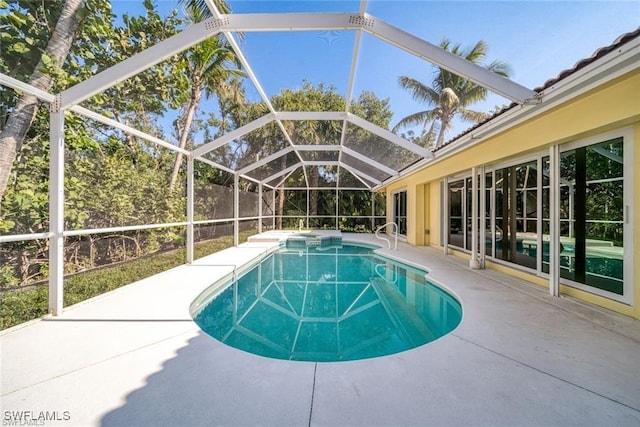 view of pool with a lanai and a patio area