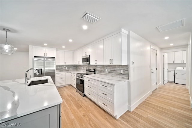 kitchen featuring light hardwood / wood-style floors, white cabinets, pendant lighting, stainless steel appliances, and sink