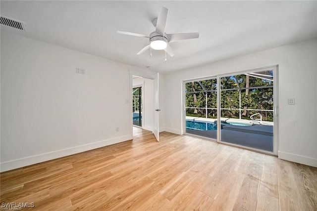 empty room featuring light wood-type flooring and ceiling fan