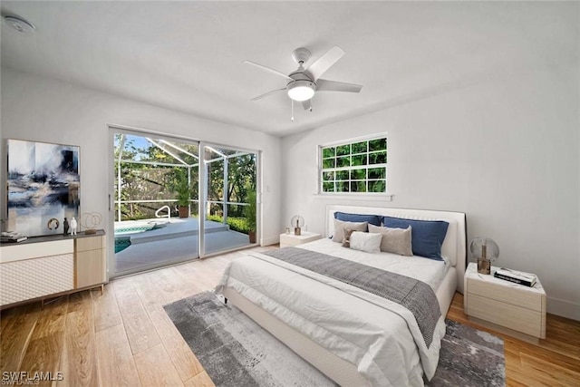 bedroom with ceiling fan, wood-type flooring, access to outside, and multiple windows