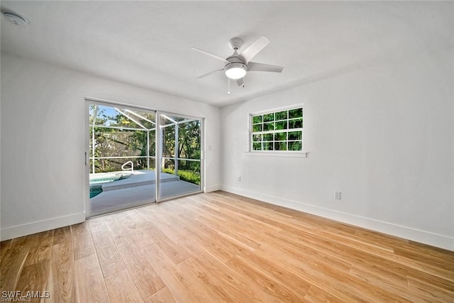 unfurnished room featuring light wood-type flooring, ceiling fan, and plenty of natural light