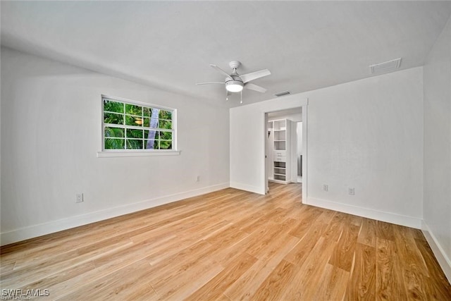 empty room with ceiling fan and light hardwood / wood-style flooring