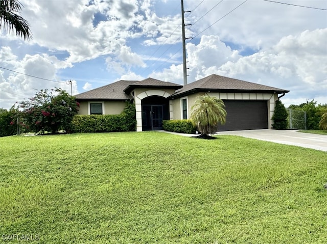 view of front of home with a front yard and a garage