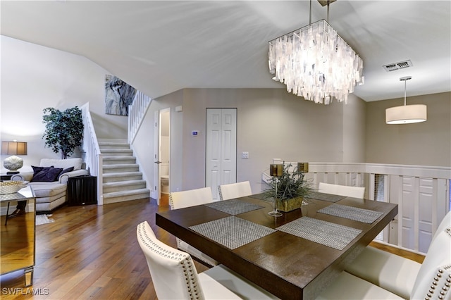 dining room featuring a notable chandelier and dark wood-type flooring