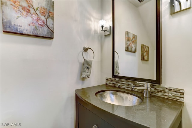 bathroom with vanity and tasteful backsplash