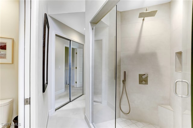 bathroom with toilet and an enclosed shower