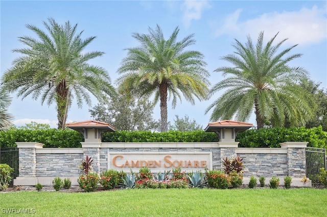 community / neighborhood sign with a lawn