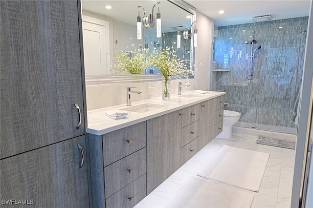 bathroom with tiled shower, vanity, and toilet