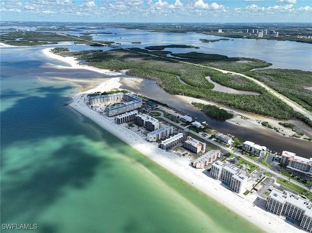 birds eye view of property featuring a beach view and a water view