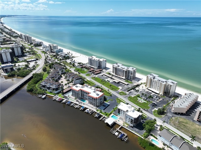 bird's eye view with a water view and a beach view