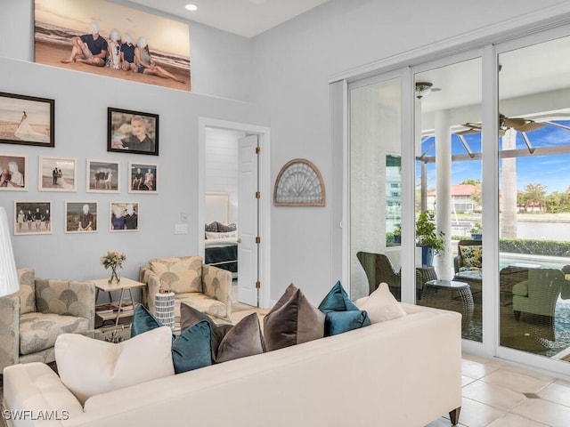 living room featuring ceiling fan and light tile patterned flooring