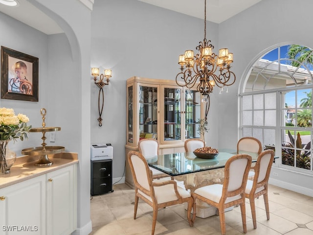 dining room featuring a chandelier and light tile patterned floors