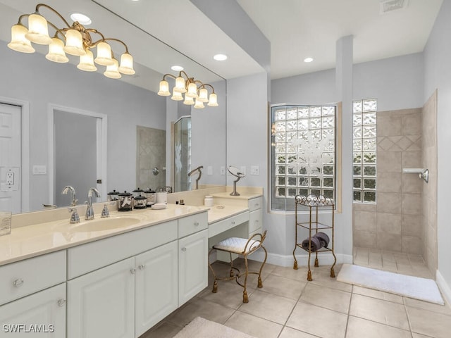 bathroom featuring tile patterned floors, vanity, and tiled shower