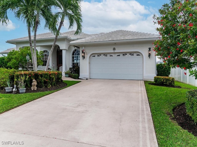 ranch-style home featuring a garage and a front lawn