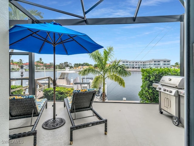 view of patio with a water view, area for grilling, and a balcony