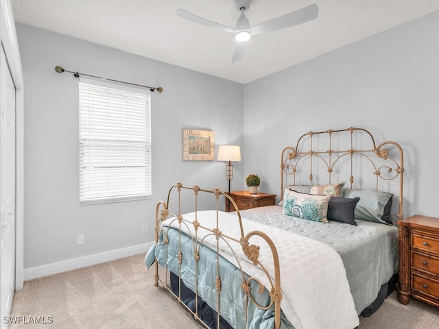 carpeted bedroom with a closet and ceiling fan