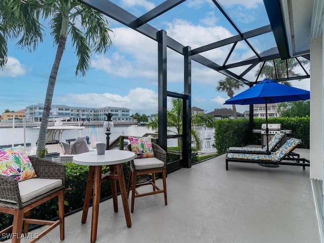 view of patio / terrace featuring a balcony and a water view