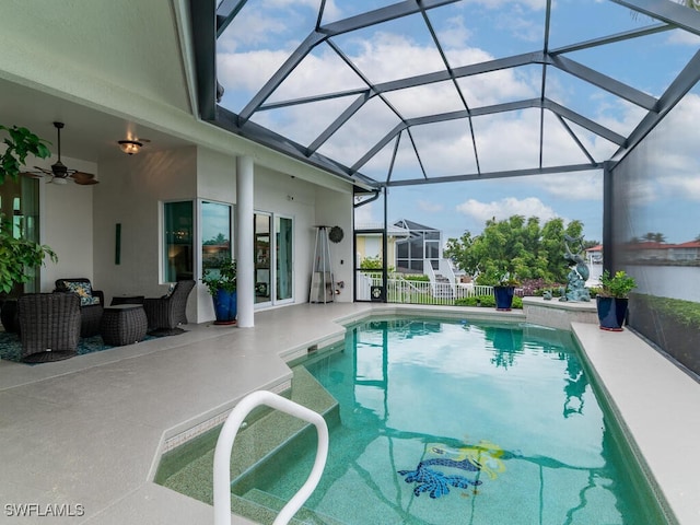 view of pool featuring a lanai, ceiling fan, and a patio area