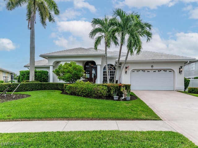 view of front of house with a garage and a front lawn