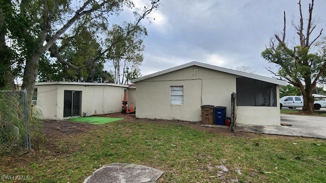 view of side of property with a lawn