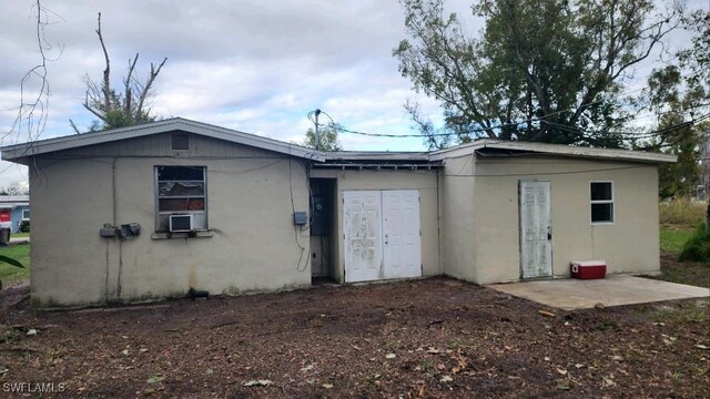 rear view of house featuring cooling unit