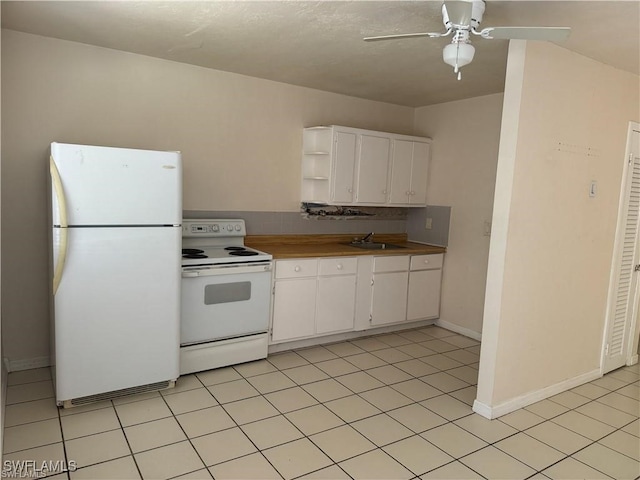 kitchen with sink, white cabinetry, white appliances, light tile patterned floors, and ceiling fan