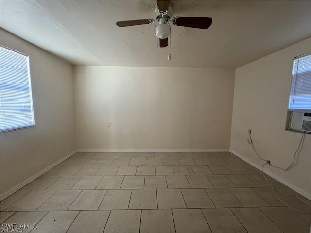 spare room featuring ceiling fan and light tile patterned flooring