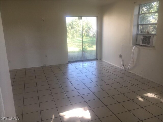 spare room featuring tile patterned floors and a healthy amount of sunlight