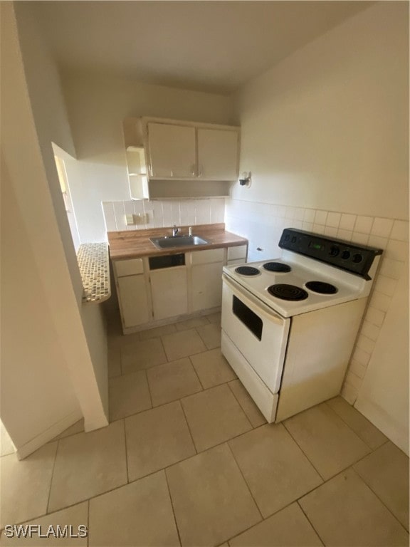 kitchen with white cabinets, white electric range oven, tasteful backsplash, and sink