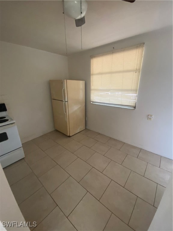 kitchen with ceiling fan, light tile patterned floors, and white appliances