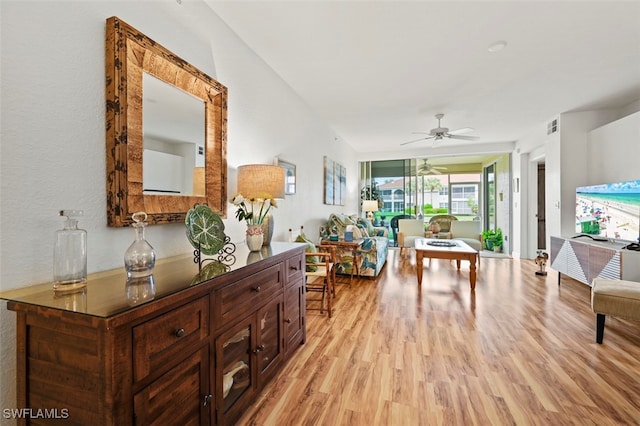 living room with ceiling fan and light hardwood / wood-style flooring