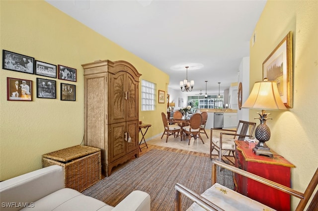 living room with light hardwood / wood-style flooring and a notable chandelier