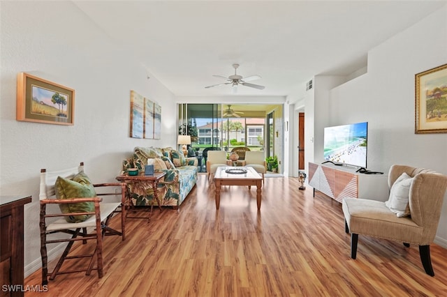 living room with ceiling fan and light hardwood / wood-style floors