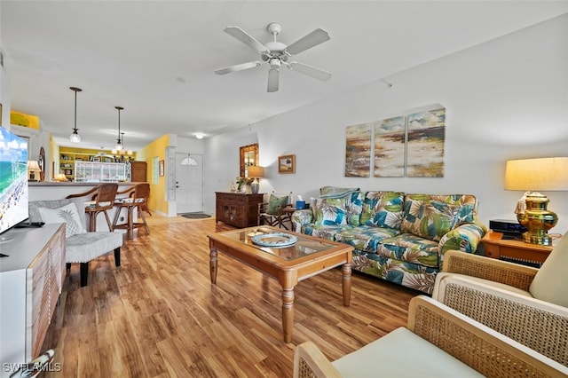 living room with light hardwood / wood-style floors and ceiling fan