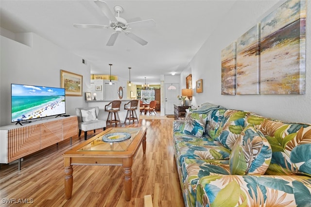 living room with ceiling fan and hardwood / wood-style flooring