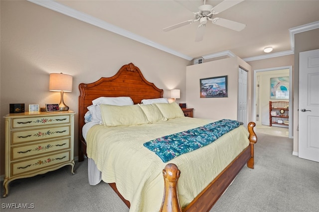 carpeted bedroom featuring ceiling fan, a closet, and ornamental molding