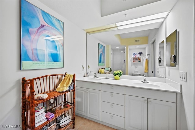 bathroom with an enclosed shower, vanity, and tile patterned floors