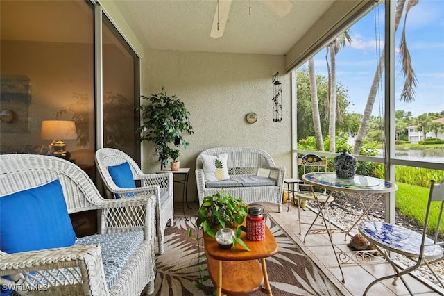 sunroom / solarium featuring ceiling fan