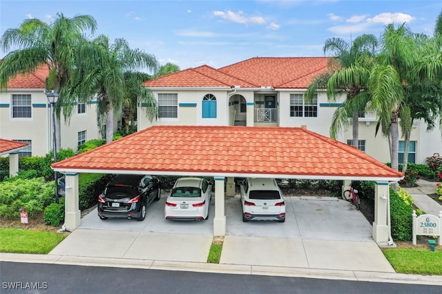 mediterranean / spanish house featuring a carport