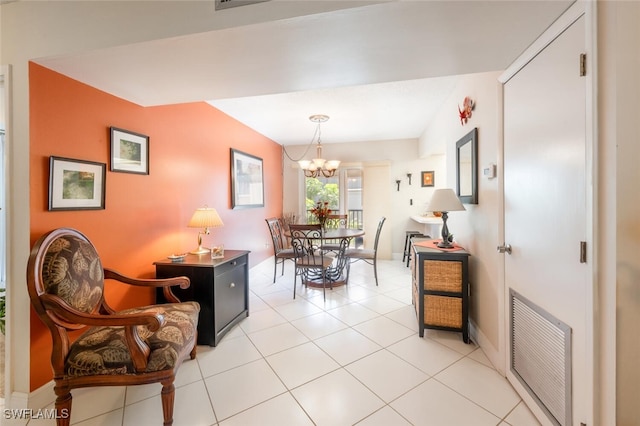 dining area featuring an inviting chandelier and light tile patterned floors