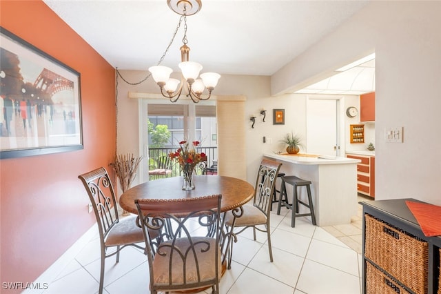 tiled dining room featuring a chandelier