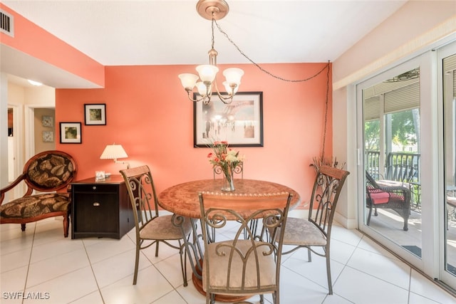 tiled dining space featuring an inviting chandelier