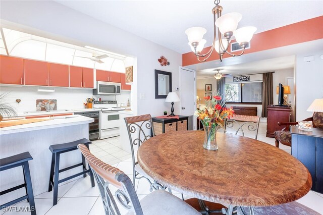 dining space featuring ceiling fan with notable chandelier and light tile patterned floors