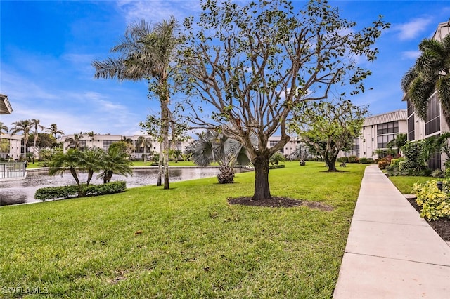 surrounding community featuring a yard and a water view