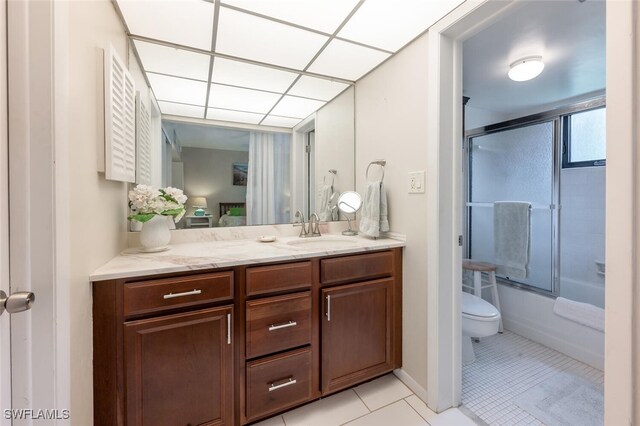 full bathroom with shower / bath combination with glass door, vanity, toilet, and tile patterned floors